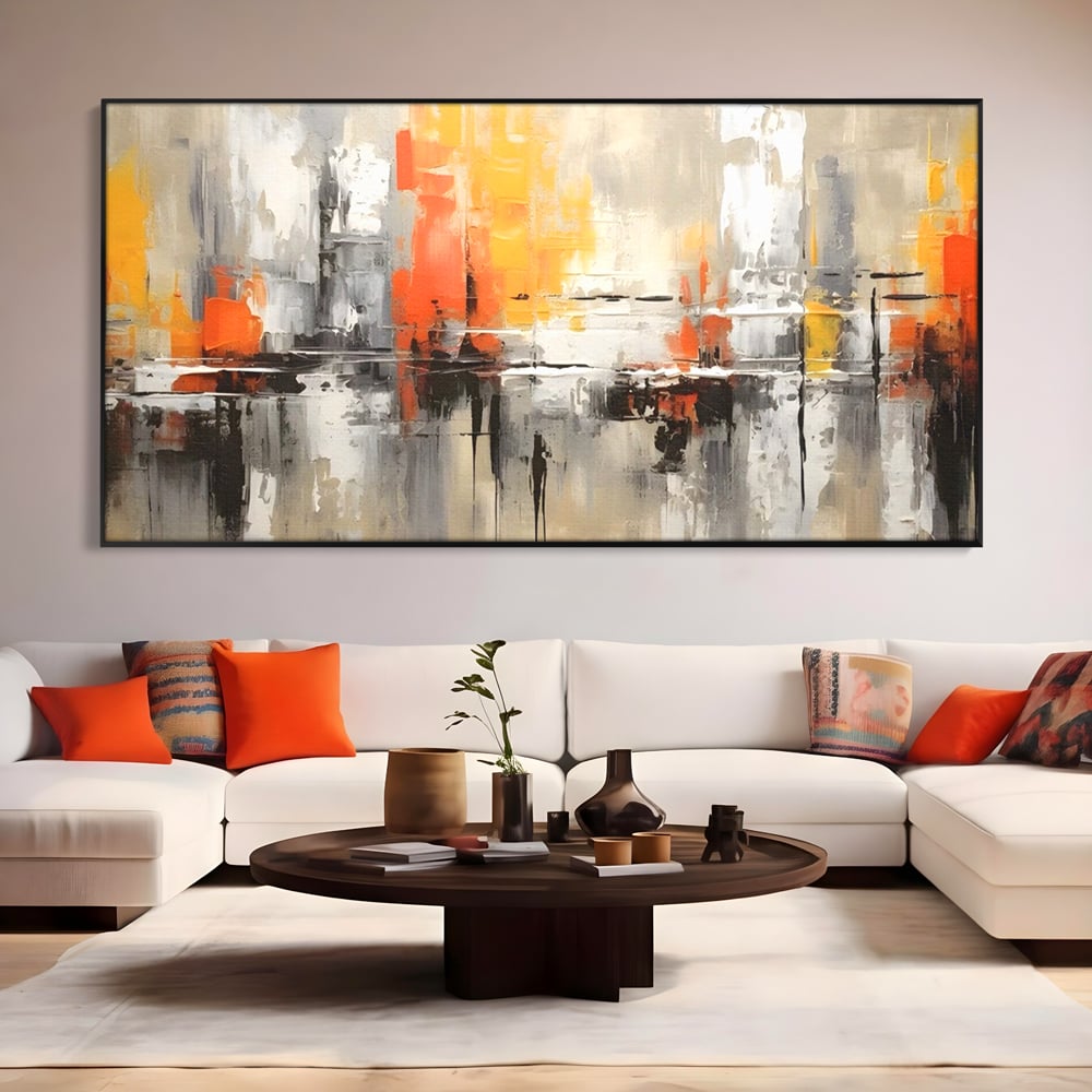 Tablou canvas cu pictura abstracta cu turnuri portocalii, in rama de aluminiu negru, pe perete intr-un living